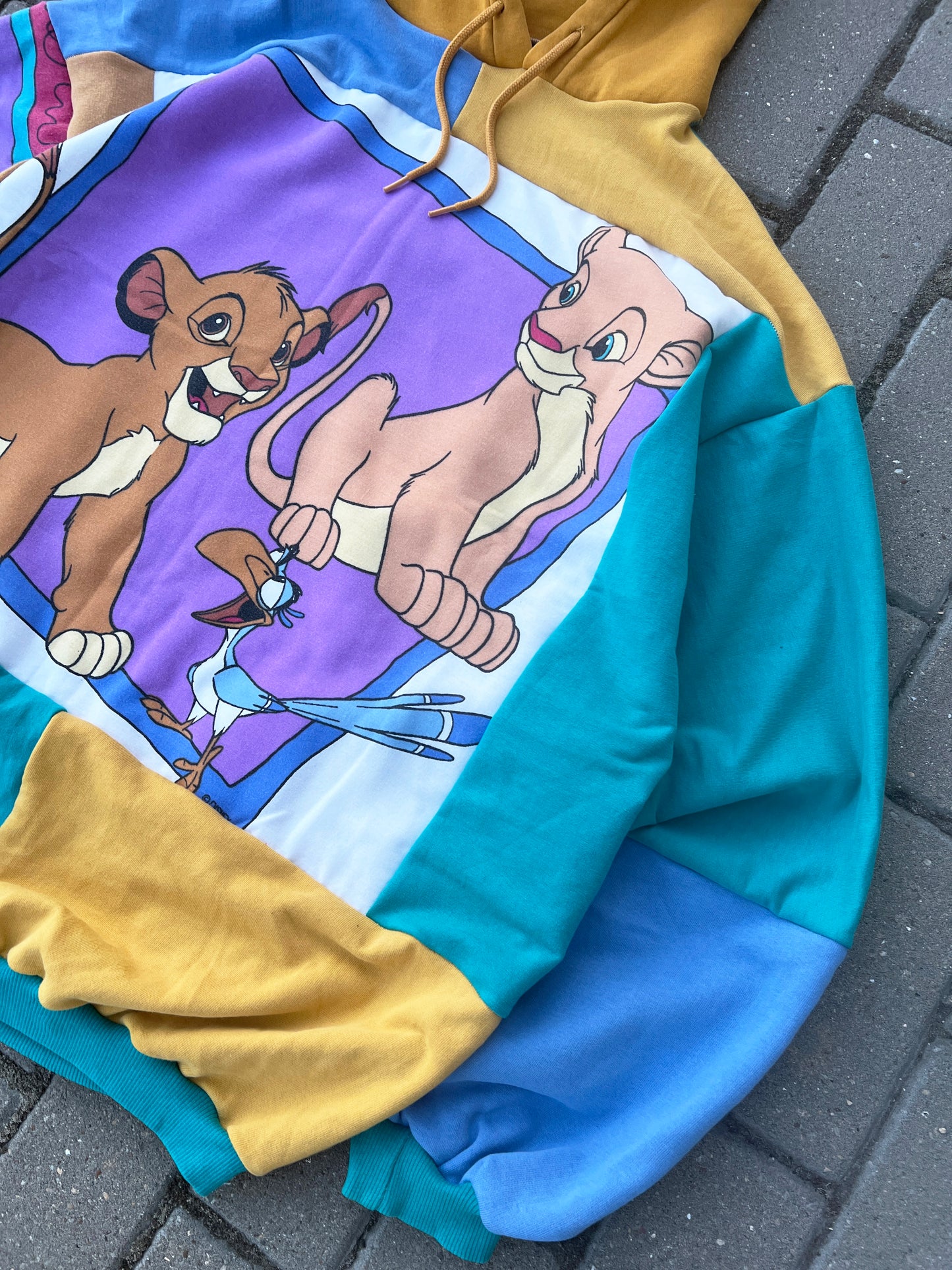'CAN YOU FEEL THE LOVE TONIGHT' PATCHWORK HOODIE (L)